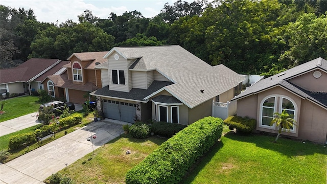 view of front of property with a garage and a front lawn