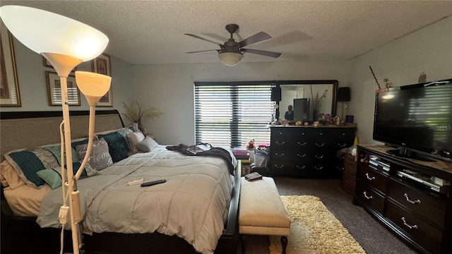 carpeted bedroom featuring ceiling fan and a textured ceiling