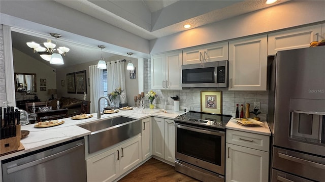 kitchen with stainless steel appliances, sink, and white cabinetry