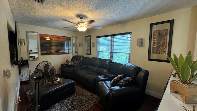 living room featuring a textured ceiling, dark hardwood / wood-style flooring, and ceiling fan