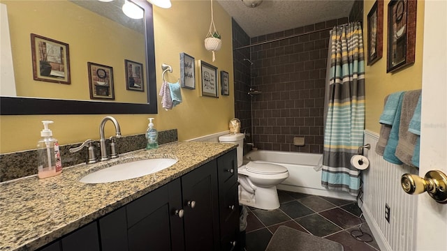 full bathroom with a textured ceiling, shower / bathtub combination with curtain, tile patterned floors, vanity, and toilet