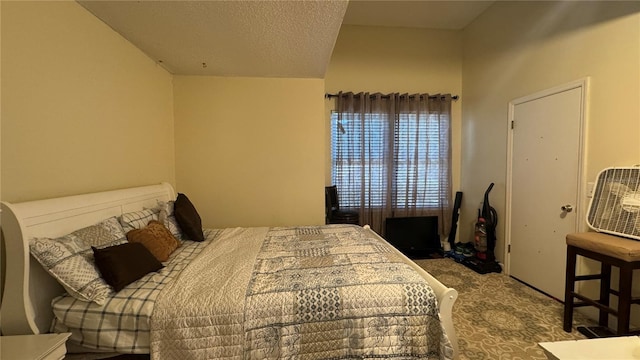 bedroom with a textured ceiling and carpet floors