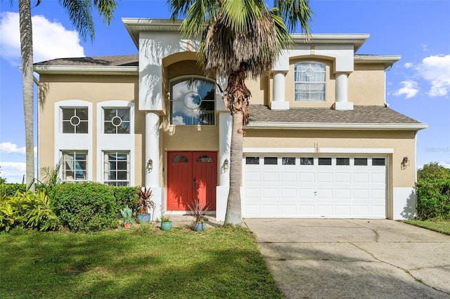 mediterranean / spanish-style house with a garage and a front lawn