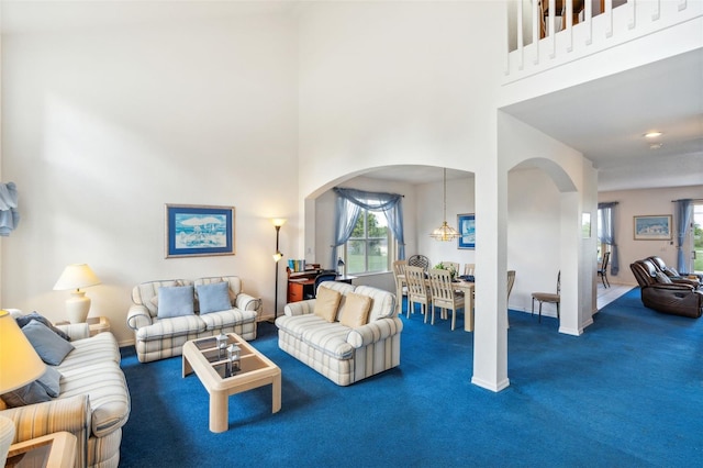 carpeted living room featuring a high ceiling