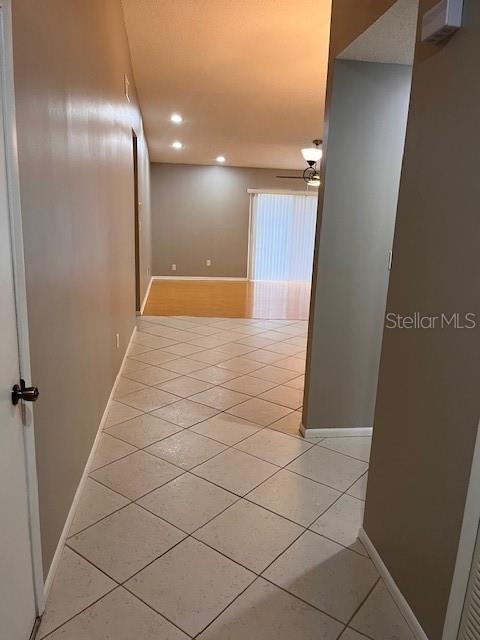 hallway featuring light tile patterned floors