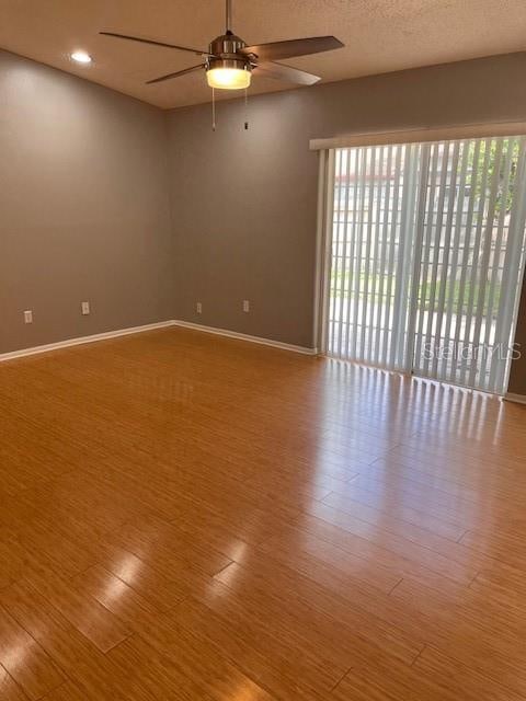 empty room featuring hardwood / wood-style floors and ceiling fan