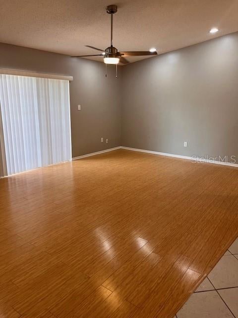 spare room featuring hardwood / wood-style floors, a textured ceiling, and ceiling fan