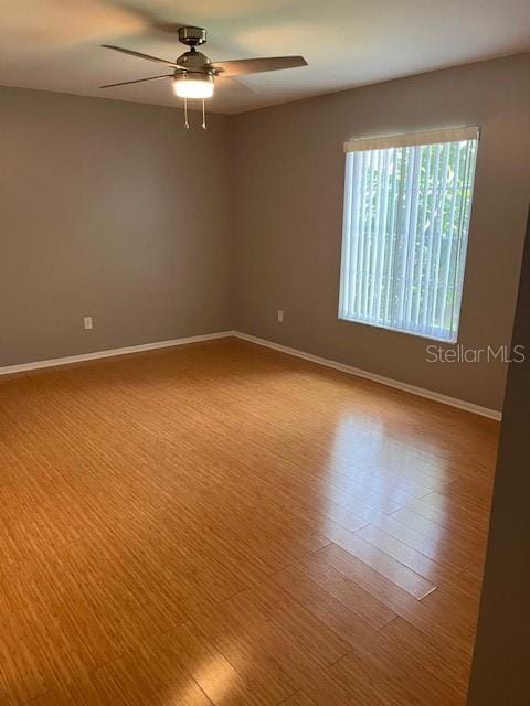 empty room with ceiling fan and light wood-type flooring