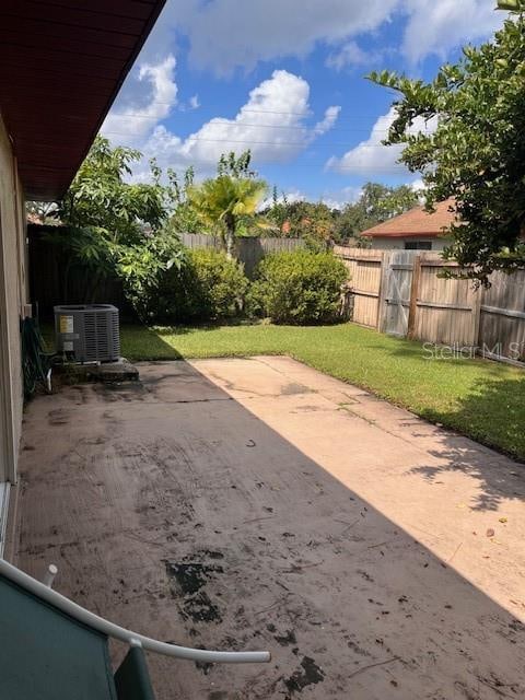 view of yard featuring a patio and central AC unit