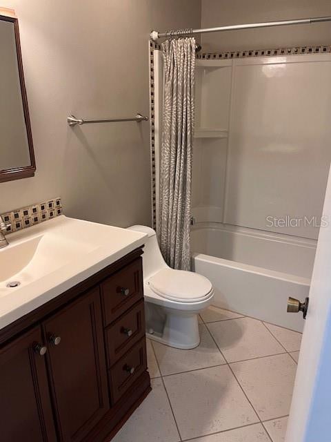 full bathroom with vanity, toilet, tile patterned floors, and shower / tub combo with curtain