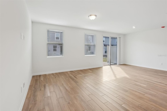 unfurnished room featuring a healthy amount of sunlight and light wood-type flooring