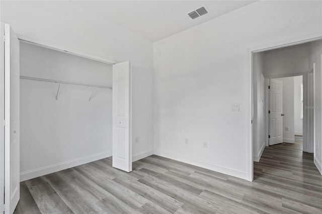 16941 SW 30th Avenue Rd SW, Ocala, FL 34473 - unfurnished bedroom with light wood-type flooring, a closet, baseboards, and visible vents