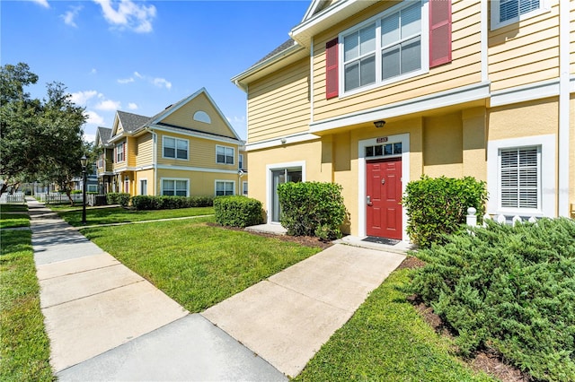 doorway to property featuring a lawn