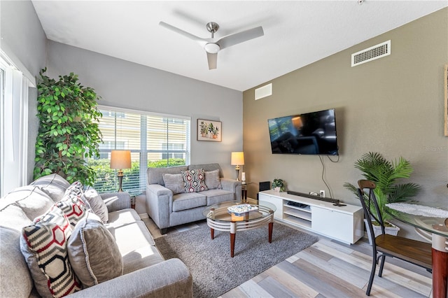 living room featuring light wood-type flooring and ceiling fan