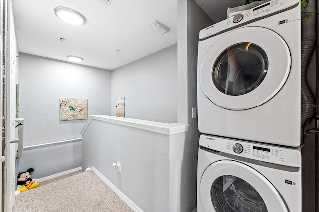 clothes washing area with stacked washer / drying machine and carpet flooring