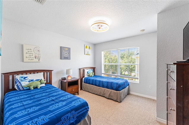 bedroom featuring a textured ceiling and carpet