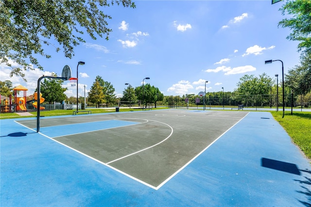 view of sport court featuring a playground