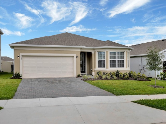 single story home featuring a front yard and a garage