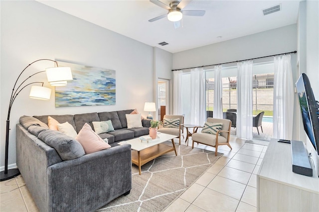 living room featuring ceiling fan and light tile patterned floors