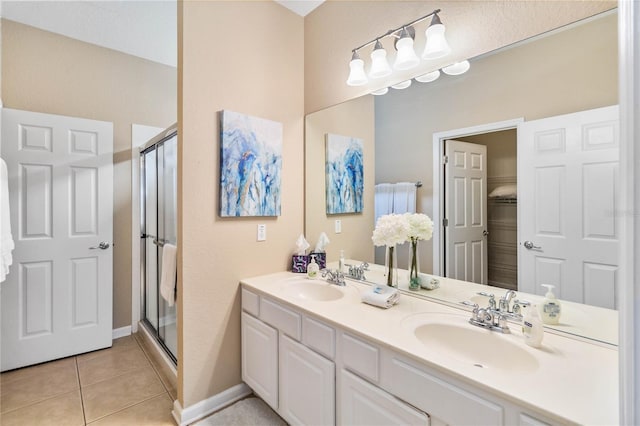 bathroom featuring vanity, an enclosed shower, and tile patterned flooring