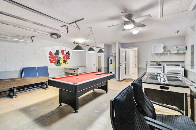 recreation room featuring a textured ceiling, billiards, ceiling fan, water heater, and washer and clothes dryer