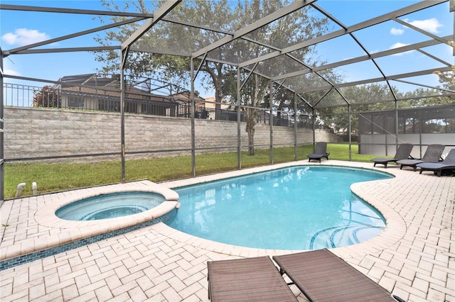 view of swimming pool featuring a lanai, a patio area, and an in ground hot tub