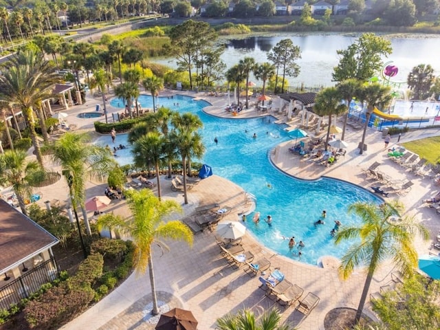 view of pool with a patio area and a water view