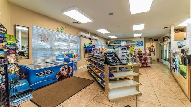 interior space with light tile patterned floors and a wall mounted AC