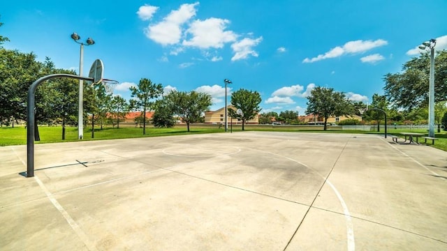 view of basketball court with a yard