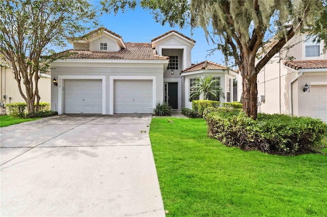 mediterranean / spanish home featuring a front yard and a garage