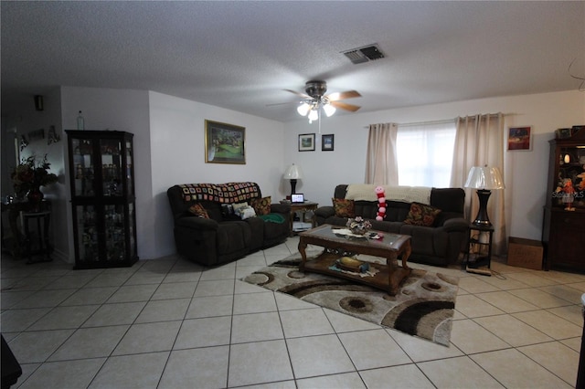 tiled living room featuring ceiling fan and a textured ceiling