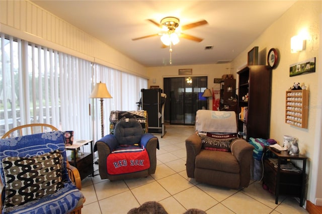 living room with ceiling fan and light tile patterned flooring