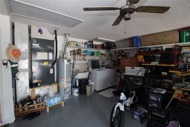 garage with washer and clothes dryer, water heater, heating unit, and ceiling fan