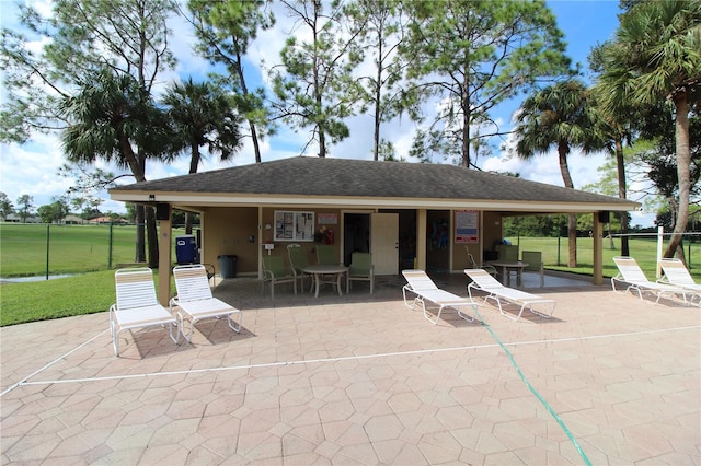 rear view of house featuring a patio area and a yard