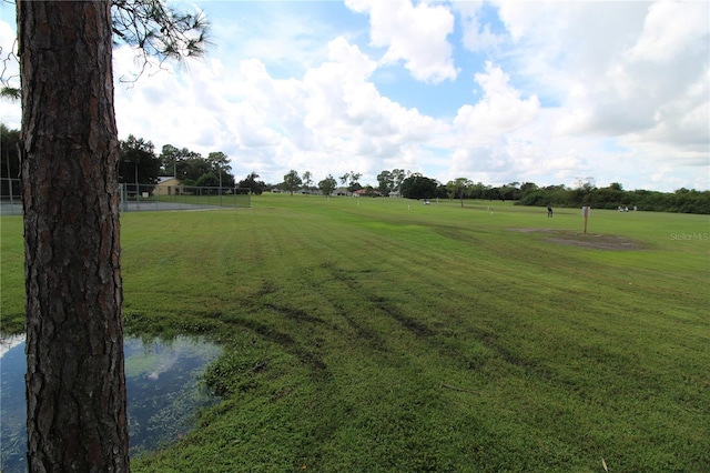 view of property's community with a yard and a water view