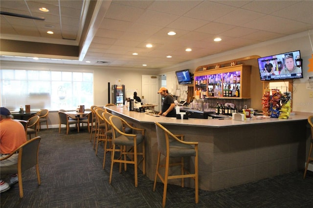 bar featuring dark carpet and ornamental molding