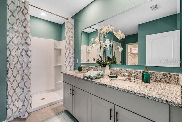 bathroom featuring vanity, tile patterned floors, and curtained shower