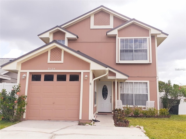 view of front of property with a front yard and a garage