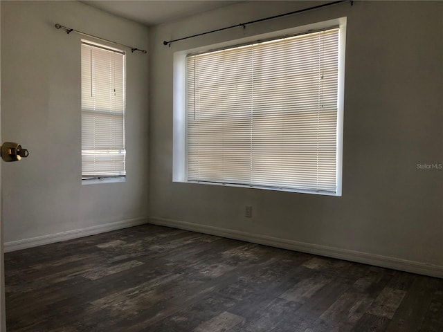 spare room featuring dark hardwood / wood-style floors