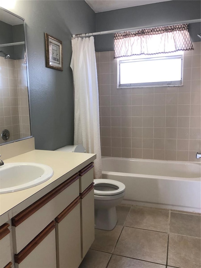 full bathroom featuring vanity, toilet, tile patterned floors, and shower / bath combination with curtain