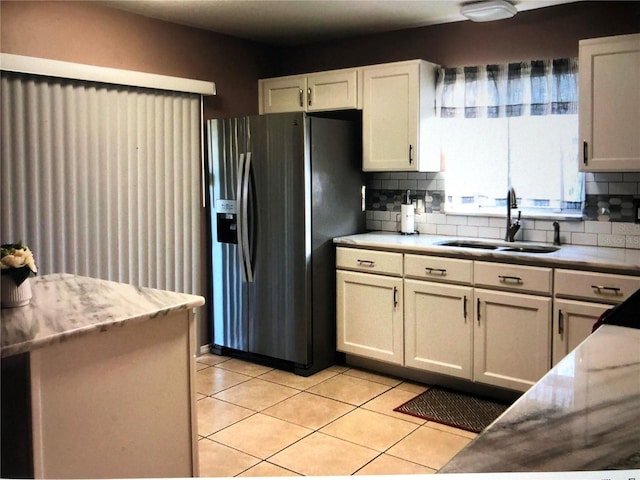 kitchen featuring sink, white cabinetry, and stainless steel fridge with ice dispenser