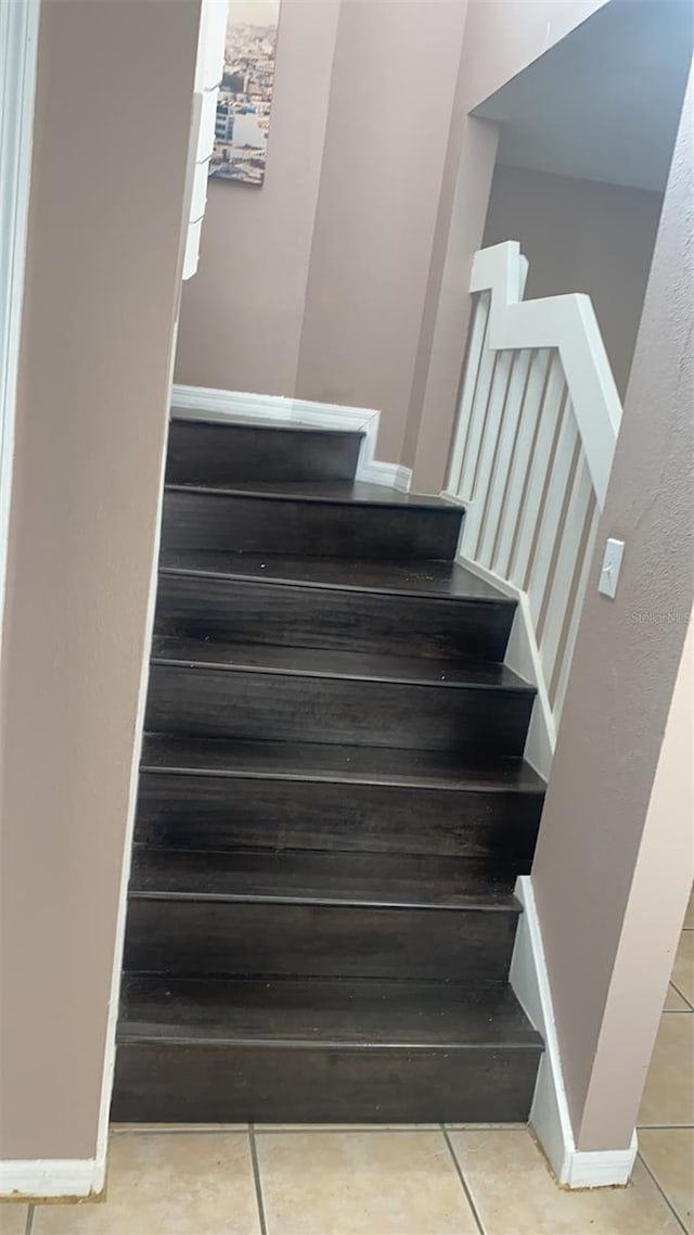 stairs featuring tile patterned flooring