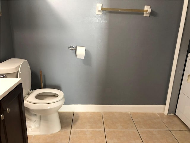 bathroom featuring vanity, tile patterned floors, and toilet