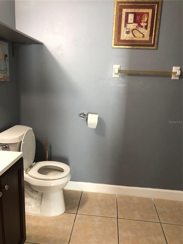 bathroom with vanity, toilet, and tile patterned floors