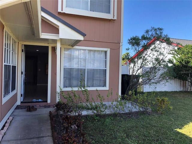 view of exterior entry with a lawn