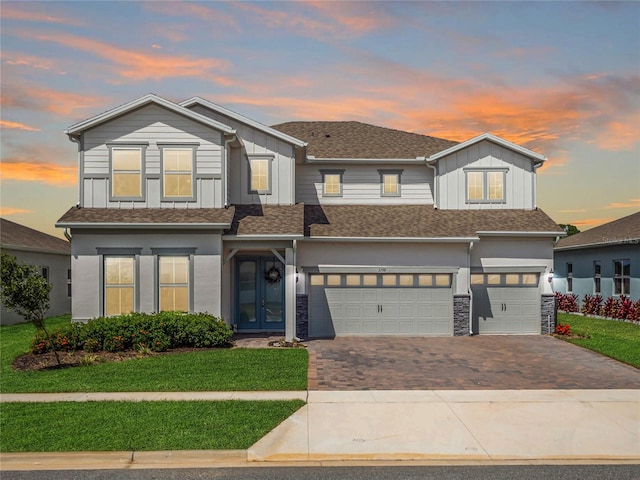 view of front of property with a lawn and a garage