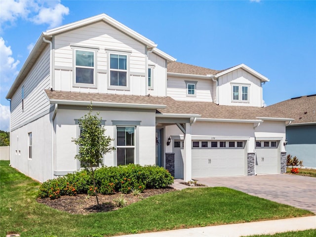 view of front of house with a garage and a front lawn