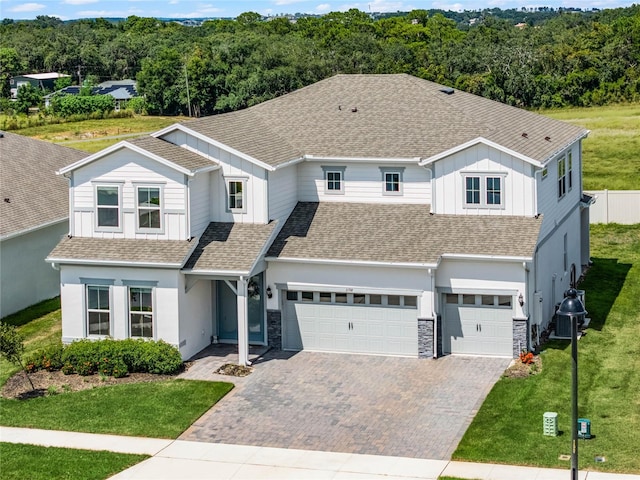 view of front of home featuring a front yard and a garage