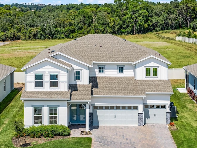 view of front of property with a front yard and a garage