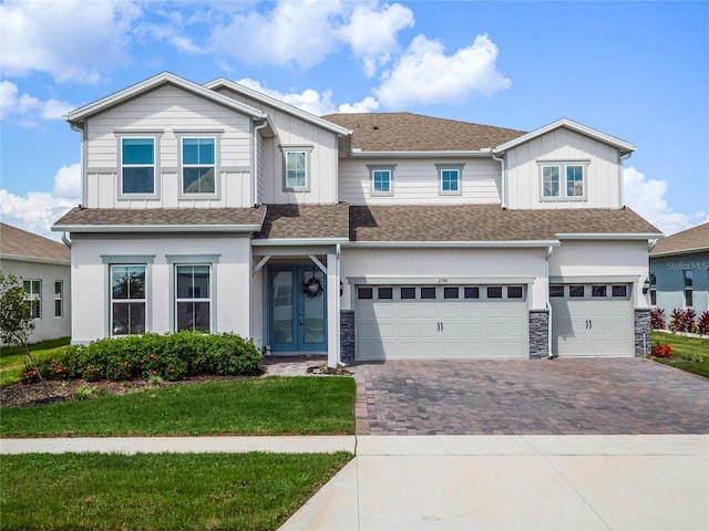 view of front facade with a front yard and a garage